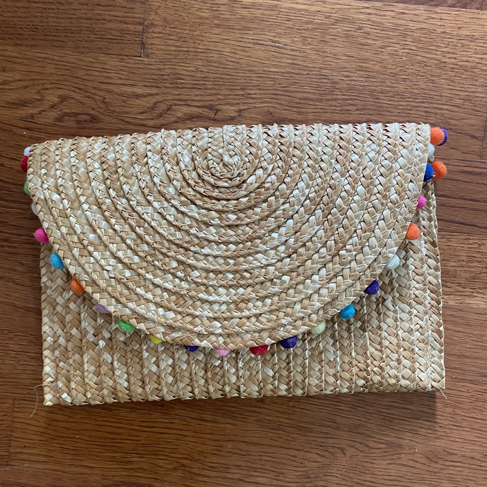 Shiraleah straw clutch with Pom Pom detail